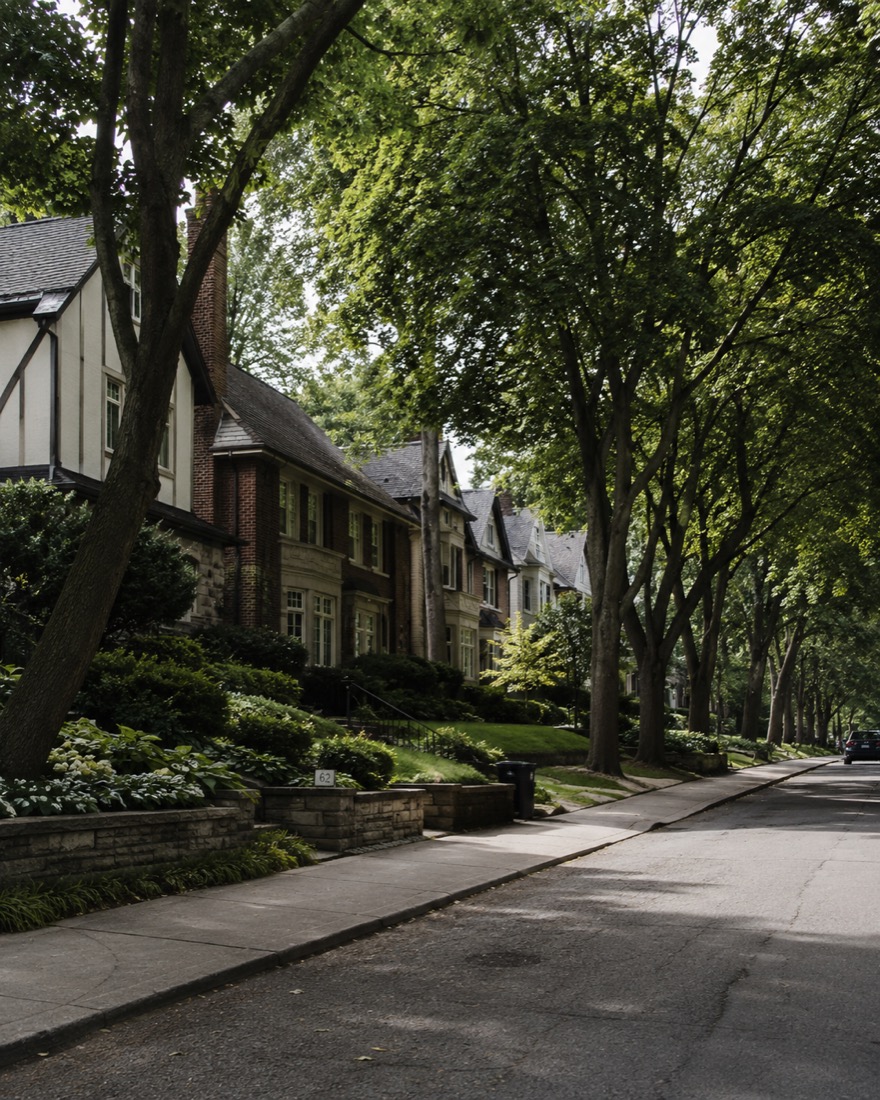 Forest Hill, Toronto streetscape — Tudor brick homes under a mature tree canopy