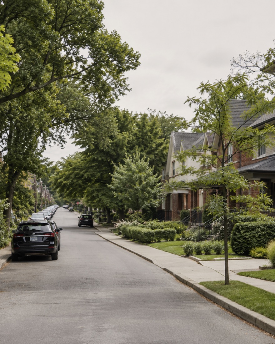Leaside, Toronto — tree-lined residential street with brick semi-detached homes under overcast light
